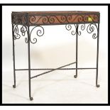 A vintage 20th Century copper planter set within an ebonised scroll work iron frame. Measures 62