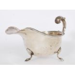 A hallmarked silver sauce boat by S Blanckensee & Son Ltd  raised on tripod feet with gadrooned edge