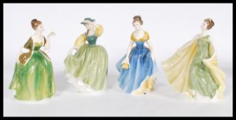 A group of four Royal Doulton ceramic figures to include HN2309, HN2368, HN2271 and HN2398. Please