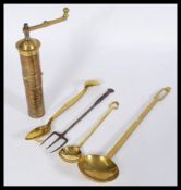 A set of 19th century brass serving spoons including a ladle, salad spoon and slotted spoon, a three