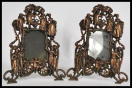 A pair of early 20th century Art Noveau cast metal mantelpiece easel mirrors having an intricate