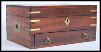 A vintage 20th century jewellery casket box having brass inlay with drawers and hinged lid with