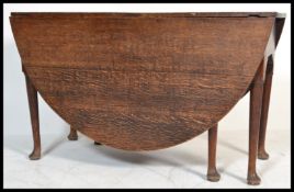 A 19th Century Georgian solid country oak large oval gate leg peg jointed dining table raised on