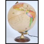 A vintage retro 20th century classical desk top globe lamp raised on a circular wooden base.