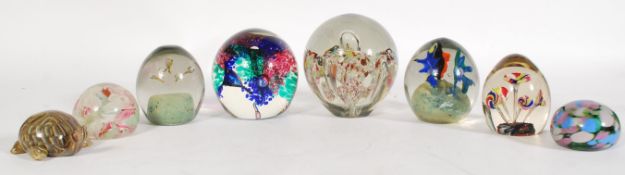 A collection of large vintage glass desk paperweights to include a helix round paperweight, a