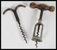 Two vintage early 20th century corkscrews including an eyebrow example by Berkeley and Co and a