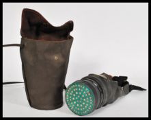 A WW2 gas mask in ladies handbag Avon 5-38 no. 2486 having a  eye window and rubber seal in ladies