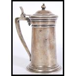 An early 20th German continental white metal silver stein, with engraved monogram, a shaped handle