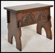 A 20th Century carved oak Jacobean revival jointed work / sewing box, hinged top revealing recess