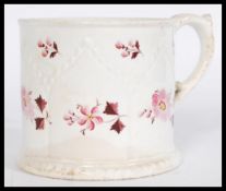 An early 19th century Georgian Regency drinking cup mug with hand painted puce floral motifs, a