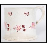 An early 19th century Georgian Regency drinking cup mug with hand painted puce floral motifs, a