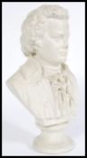 A early 20th century plaster desk bust of Mozart, raised on a circular base with name inscription.