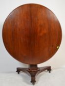 A 19th Century mahogany tilt-top breakfast table with plain frieze over a faceted baluster support