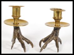 A pair of early 19th century regency Georgian Gothic candlesticks having eagle claw form brass bases