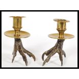 A pair of early 19th century regency Georgian Gothic candlesticks having eagle claw form brass bases