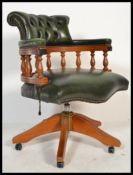 A 20th century green Leather Chesterfield captains deep button back mahogany framed swivel
