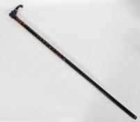 A vintage early 20th century African ebony and ivory inlaid walking stick. The handle in the form of