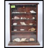 An early 20th century mahogany table top glazed display cabinet with glazed shelves complete with