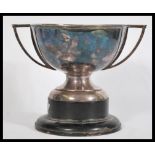 An early 20th Century twin handled silver plated Art Deco Trophy raised on an ebonised socle base.