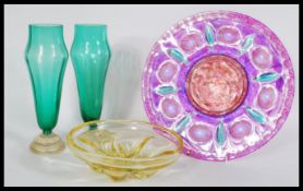 A group of vintage studio art glass to include a pair of green glass vases, a over painted large