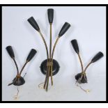 A group of three brass vintage retro 20th century wall lights with tulip sconces and chord pull