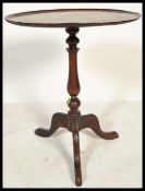 A early 19th Georgian century mahogany side wine table raised on tripod legs with a central