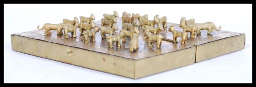 A vintage Oriental Nepal brass Bagha-Chal moving tigers game and board featuring brass tigers and