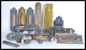 A good collection of antique architectural door fittings and furniture to include letter boxes,
