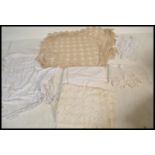A collection of vintage linens to include, a crochet rectangular table cloth, an initialed bed