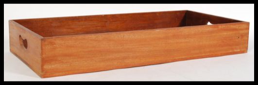 A 19th century mahogany butlers carrying tray with pierced handles to the sides.