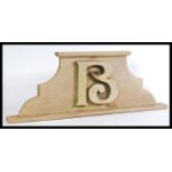 An early 20th century French wooden door pediment of ached form having a carved letter B to top.