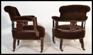 A pair of late 19th Century Victorian carved mahogany framed tub chairs with button upholstered