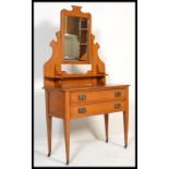 An Edwardian satin walnut dressing table chest, fitted with two long drawers raised on square