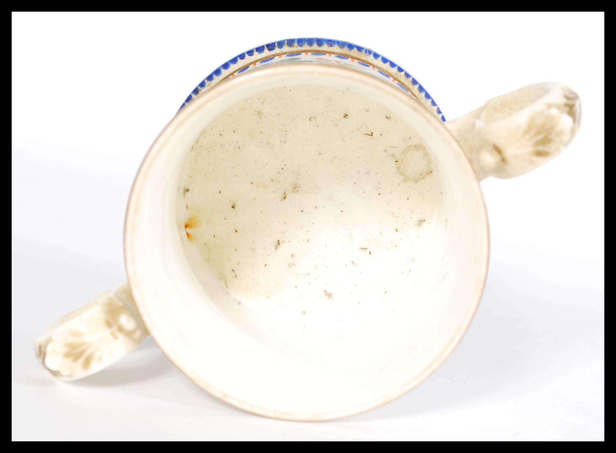 A 19th century Victorian loving cup with hand painted floral detailing, footed base, scrolled leaf - Image 3 of 4