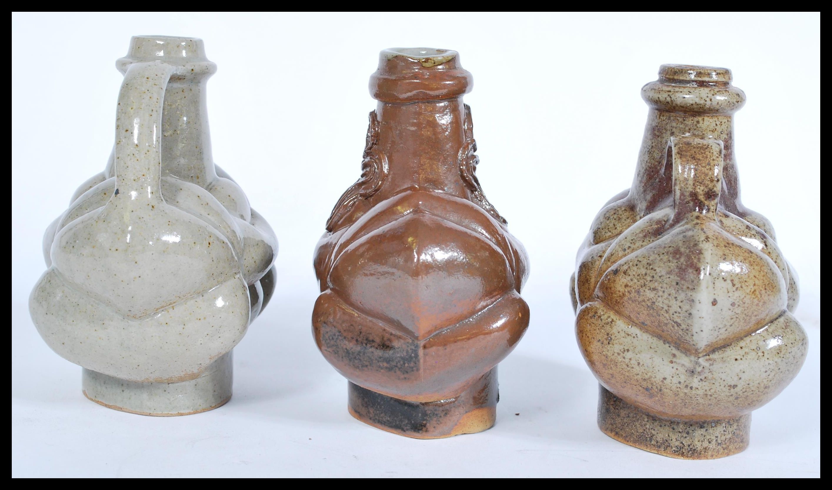 Three 17th century salt glazed stoneware jars based on bellarmine of unusual form having bulbous - Image 3 of 5