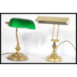 Two vintage 20th century bankers brass desk lamps one having solid brass shade and the other with