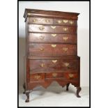 A George III oak chest on chest of drawers on stand, the moulded cornice above two short and three