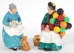 A pair of Royal Doulton figurines including 'The Favourite' H.N. 2249 figure of a lady with a cat