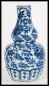 A 19th century Chinese blue and white gourd vase hand painted with flowers and leaves. measures: