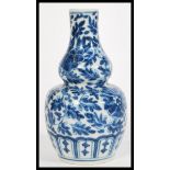A 19th century Chinese blue and white gourd vase hand painted with flowers and leaves. measures: