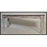 A 20th century shabby chic long refectory painted dining / skullery table. Raised on turned legs