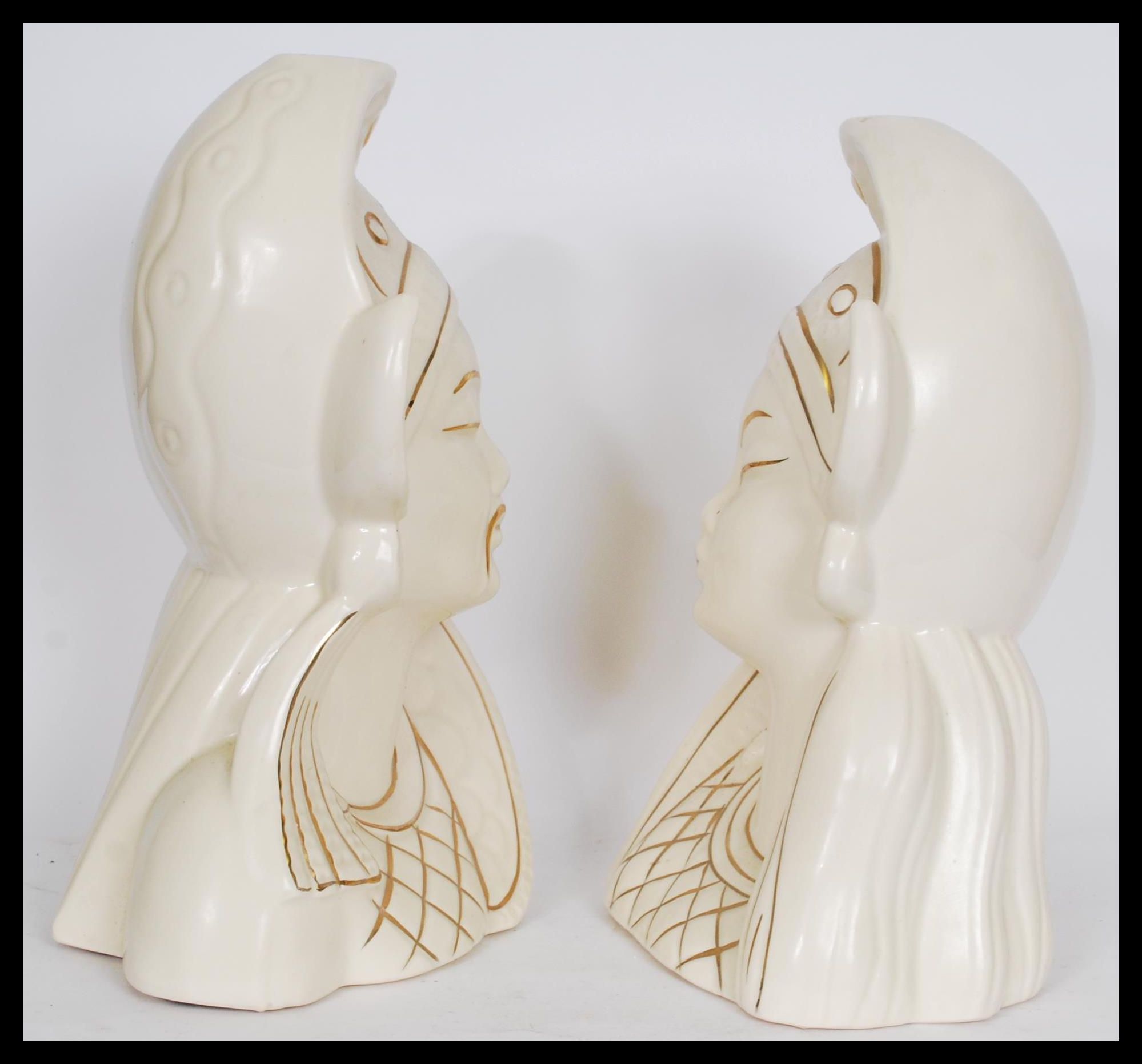 A pair of Asiatic white ceramic bust figures depicting a man and a woman in traditional dress with - Image 2 of 4