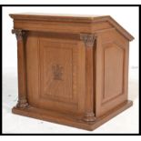 An early 20th century oak Masonic reading lectern having sloped top with carved and reeded