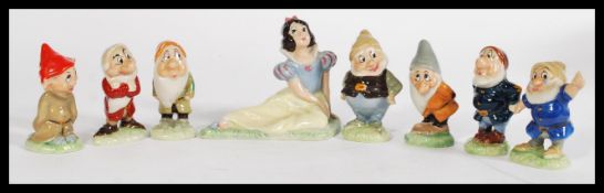 A collection of Wade second version Snow White and the Seven Dwarves whimsies, stamped to the bases.