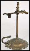 A 19th century wax jack with central bar and pierced sprung taper holder set onto a round base