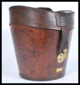 A 19th century Victorian large leather hat box having brass lock and leather straps. Opens to reveal