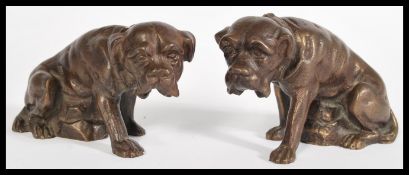 A pair of 20th century bronze / bronzed figurine of dogs having detailed features. measures: 7.5cm