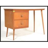 A vintage retro 20th century desk raised on tapering beech legs with red formica top above twin