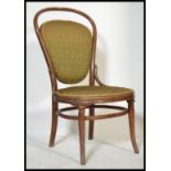 An early 20th Century Thonet bentwood nursing chair, upholstered seat pad and backrest raised on