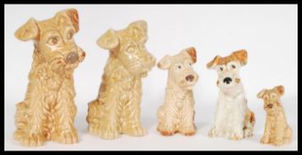 A collection of vintage 20th century graduating SylvaC ceramic figures of terriers including four of